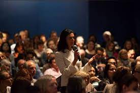 Can we learn from the past?.  Picture of an audience member asking the debate a question